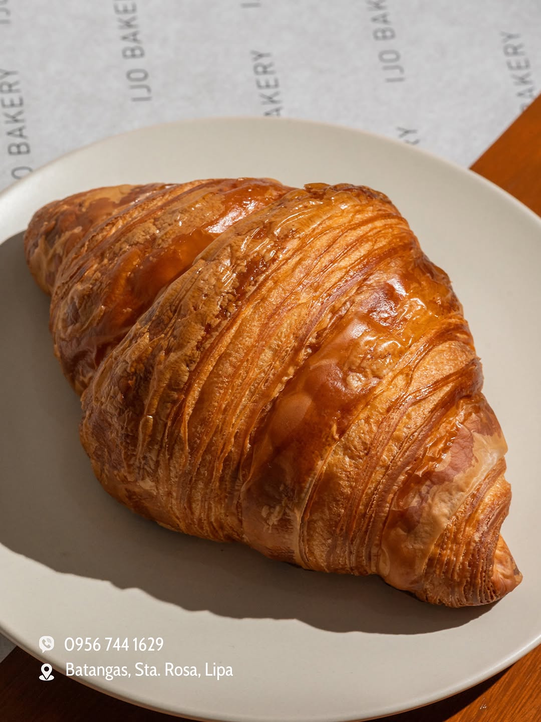 Plain croissant on IJO BAKERY branded placemat